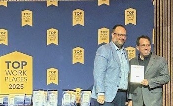 Jason receives Leadership Award on Rons behalf cropped